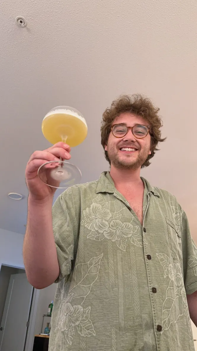 Adam raising a cocktail