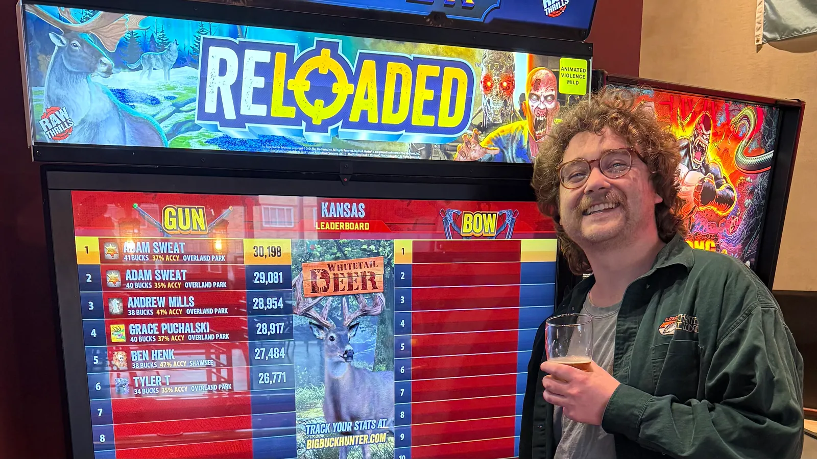 Adam Sweat grinning next to a Big Buck Hunter leaderboard he tops twice