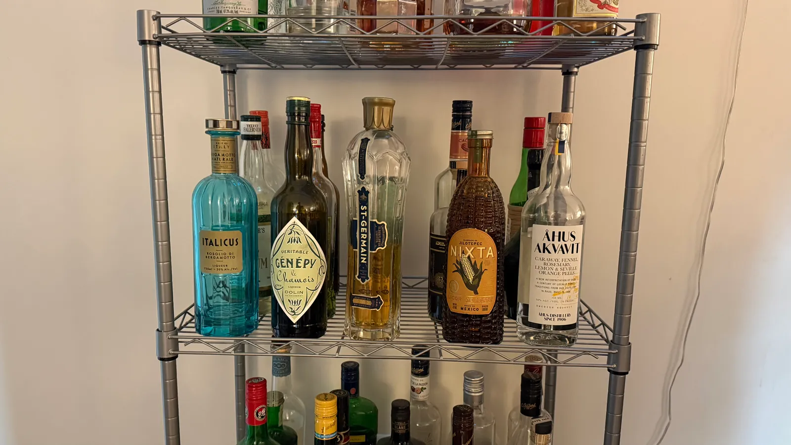 The Hum's shelves — Italicus, Génépy, St-Germain, Nixta, Åhus Akvavit